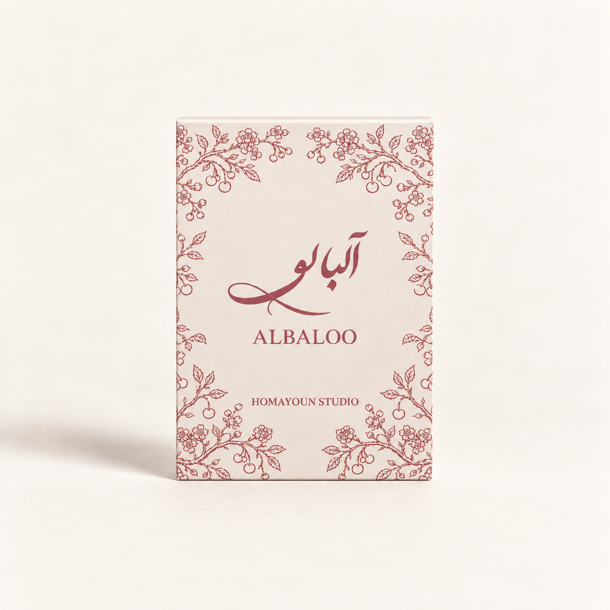 A rectangular product box for 'ALBALOO' by 'HOMAYOUN STUDIO' featuring a cream-colored background with delicate rose-pink floral borders and elegant farsi calligraphy, set against a solid off-white background.