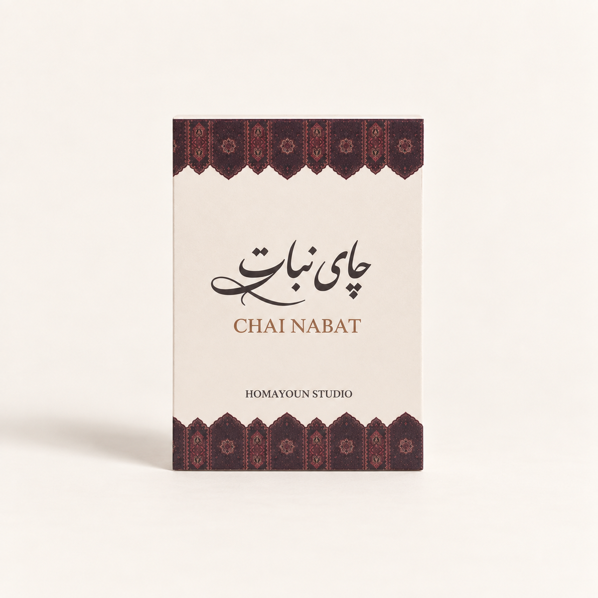 A rectangular product box for Chai Nabat by Homayoun Studio, featuring a cream-colored front with dark brown and red patterned borders at the top and bottom, and black and brown text.